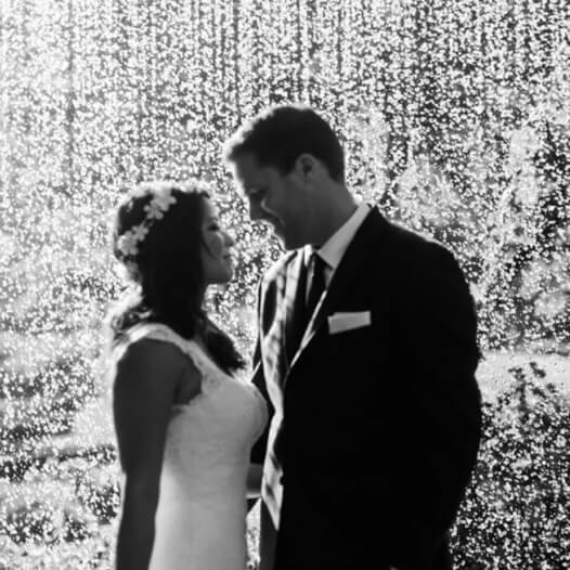 Сouple wearing a white gown and a black suit